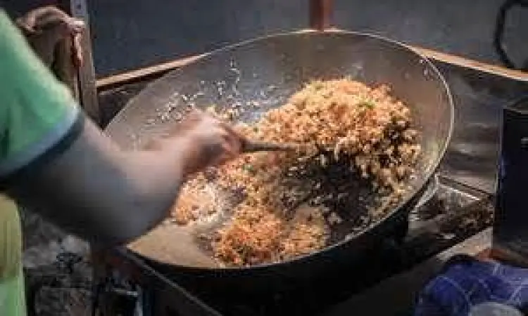 Proses memasak nasi goreng telur dengan api besar