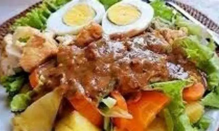 Proses memasak bumbu kacang gado gado siram di wajan