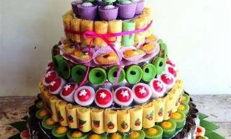 Tumpeng kue tradisional mewah dengan hiasan janur